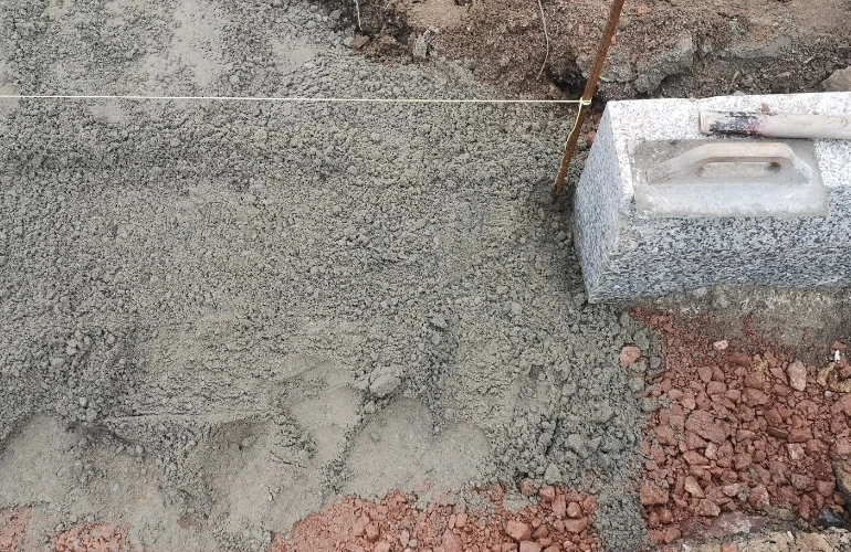 Mężczyźni nadzorujący wylewanie betonu